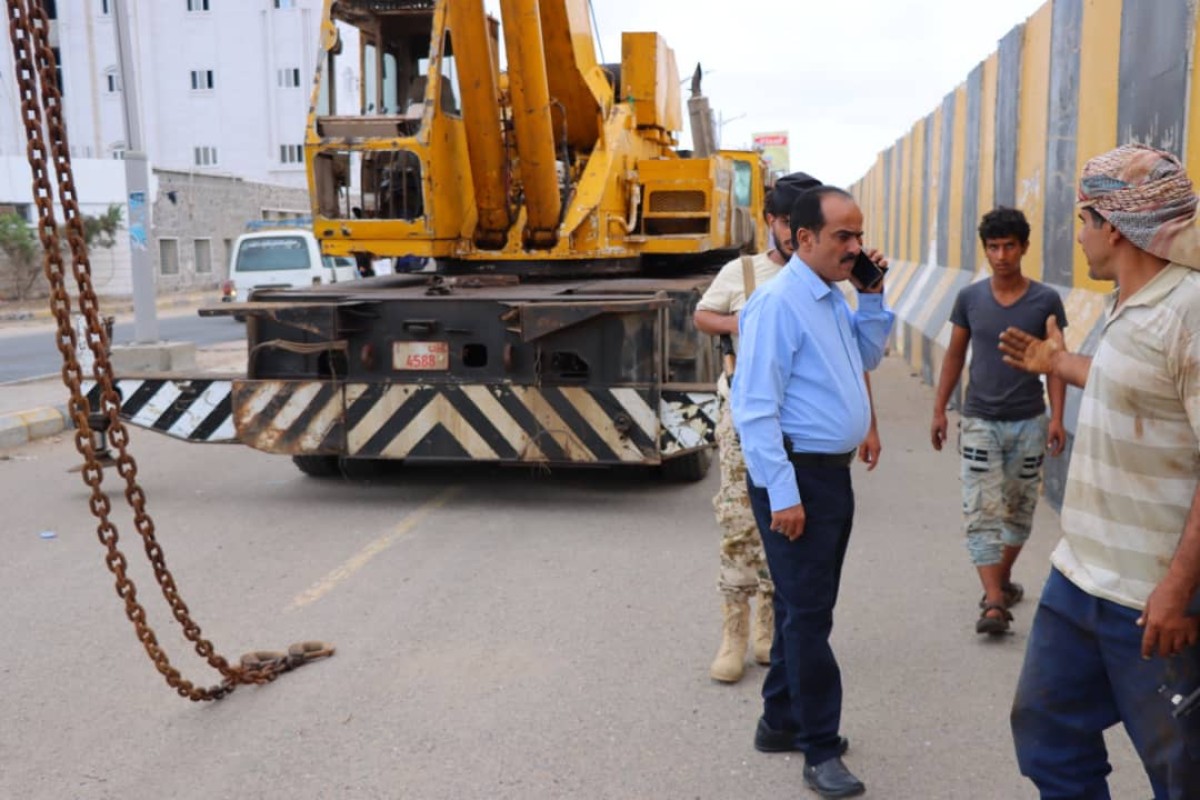 Removing concrete barriers from Airport Road in Khor Maksar after years of closure