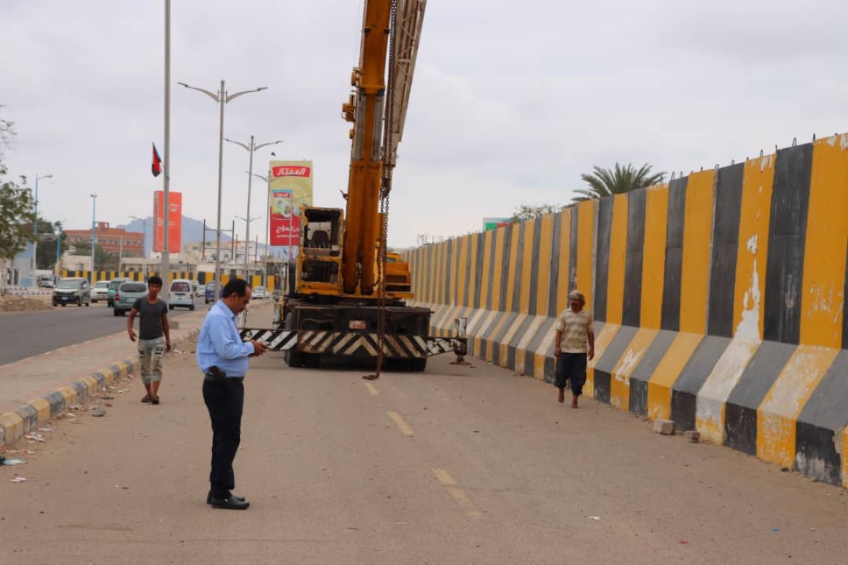 Removing concrete barriers from Airport Road in Khor Maksar after years of closure