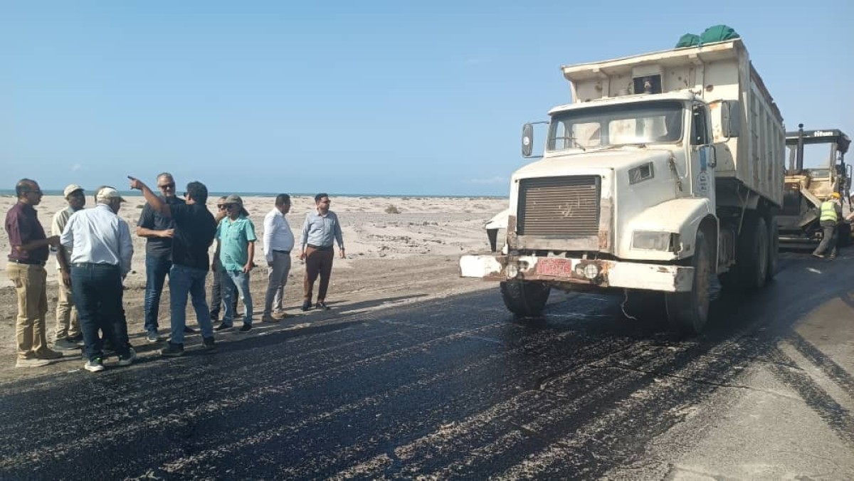 Engineer Moeen Al-Mas inspects the asphalt work on the right side of the flag line - Doufs